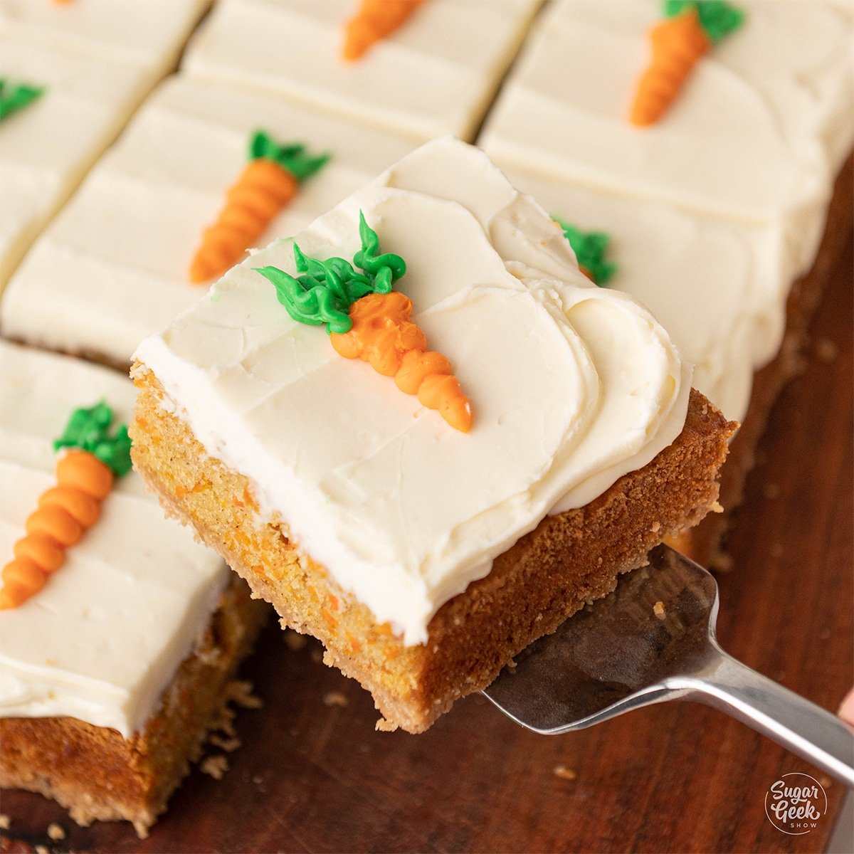 Carrot cake bar held up by a server