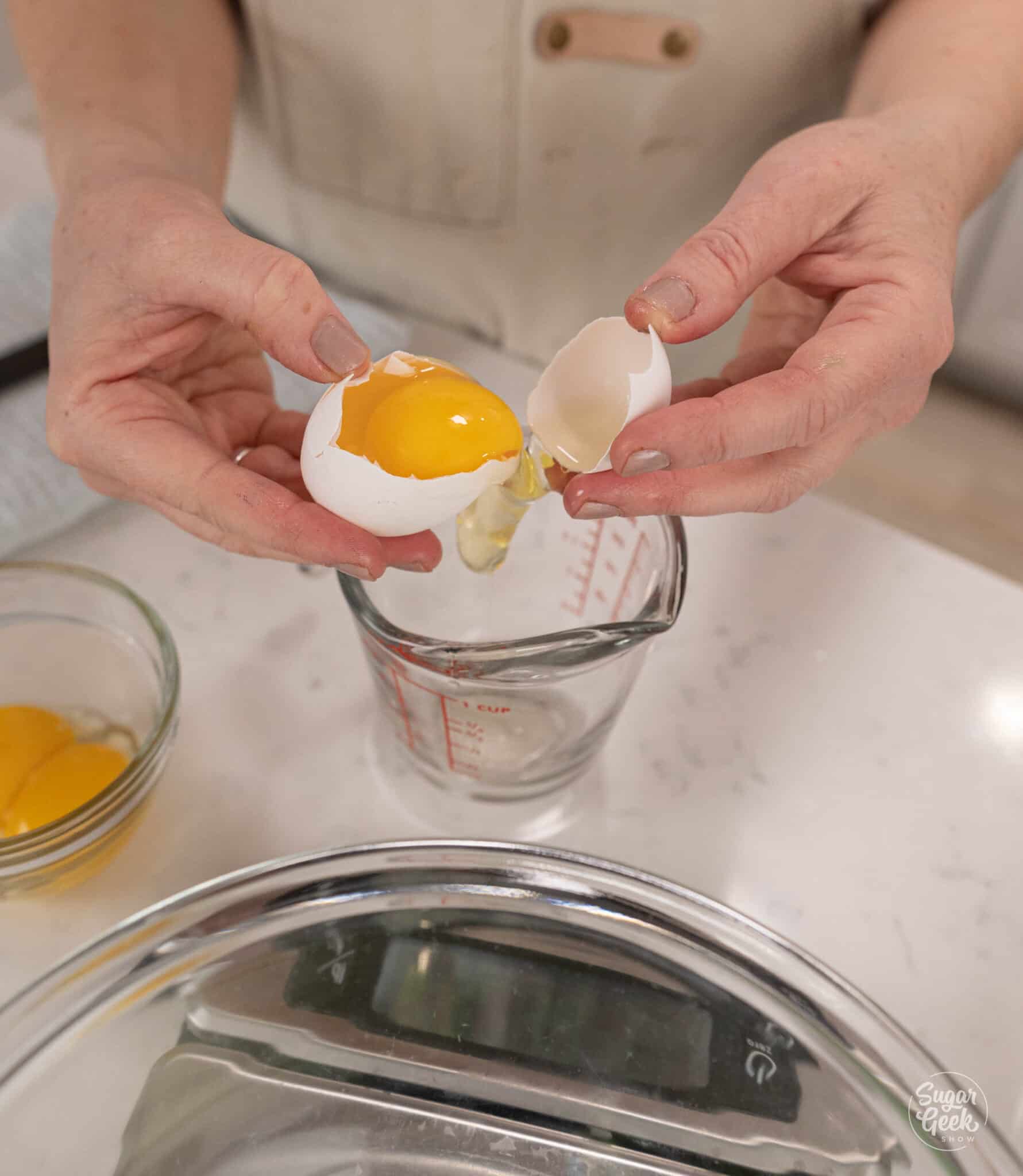 hands cracking an egg over a bowl