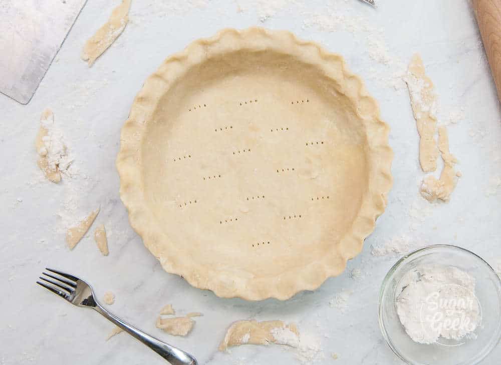 pie dough that has been rolled out into a pie plate and edges have been fluted