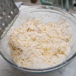 grating cold butter into the flour mixture helps keep the butter cold while you work