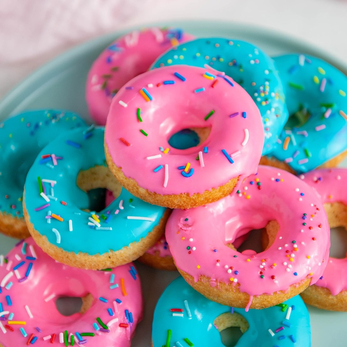 baked donuts with pink and blue glaze and sprinkles