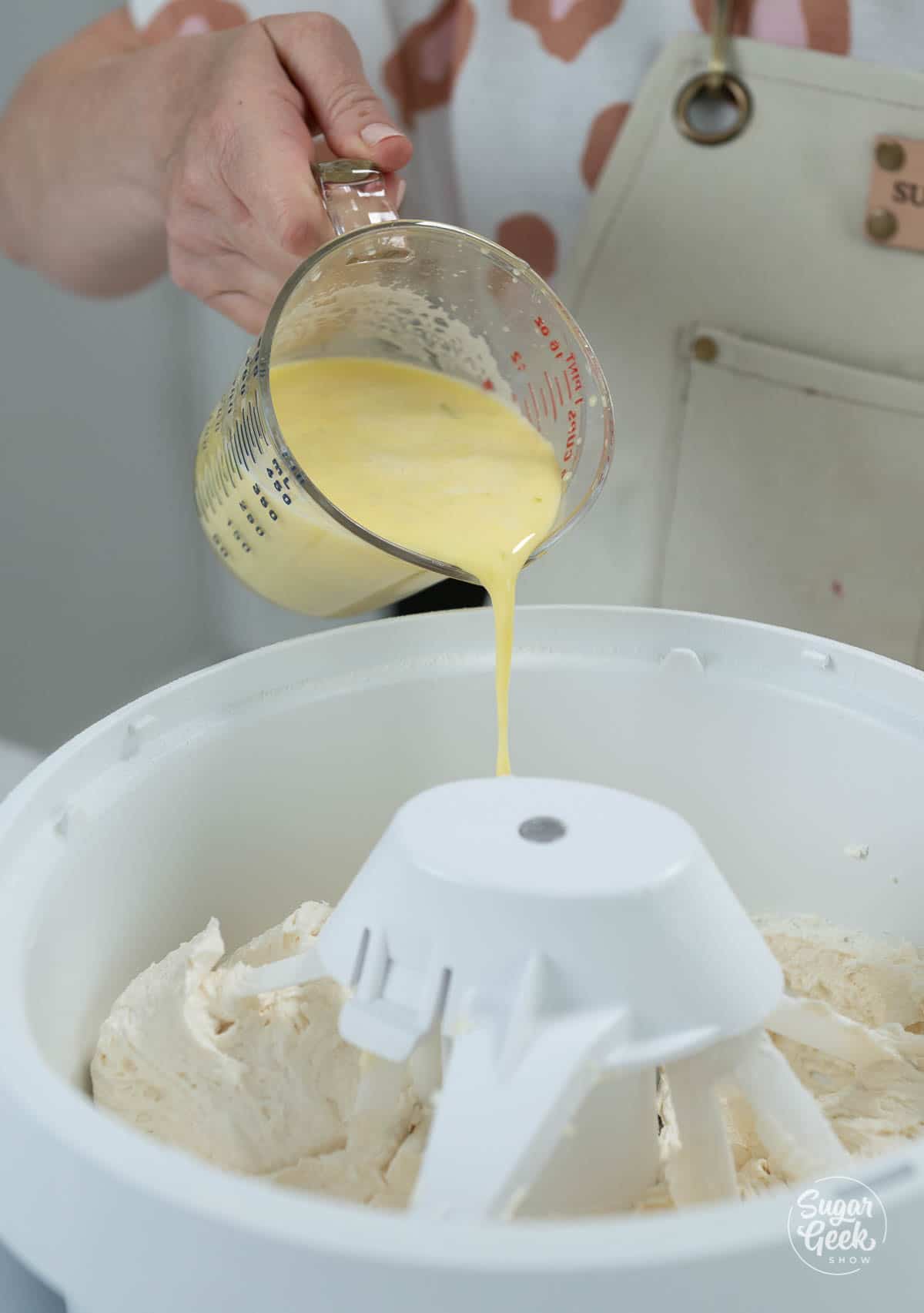 adding egg mixture to mixing cake batter