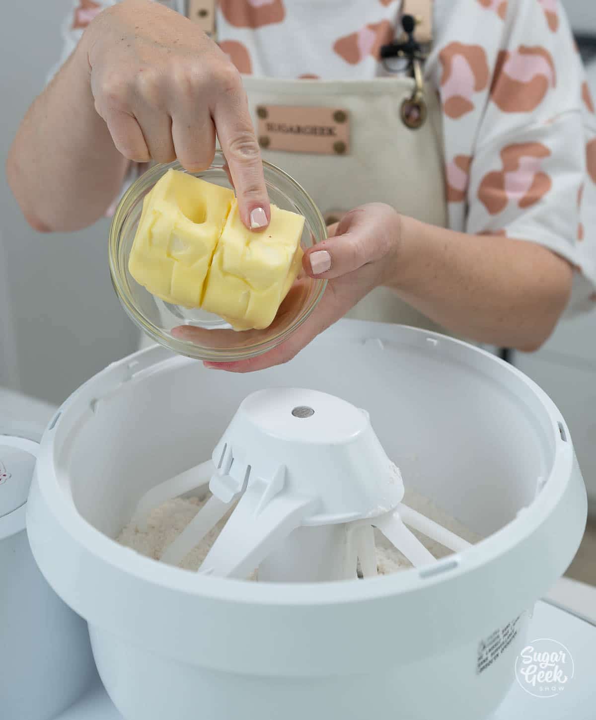 adding softened butter to dry ingredients in a stand mixer