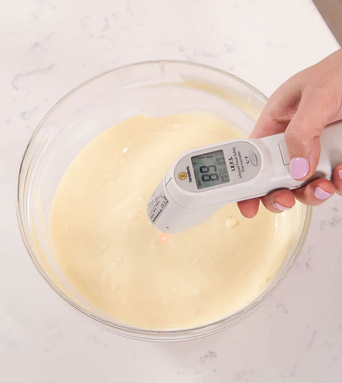 white thermometer over bowl of white chocolate
