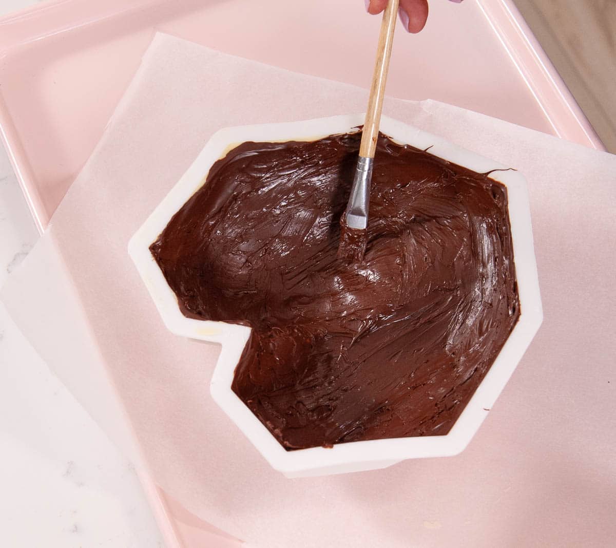 paintbrush with chocolate on a chocolate heart