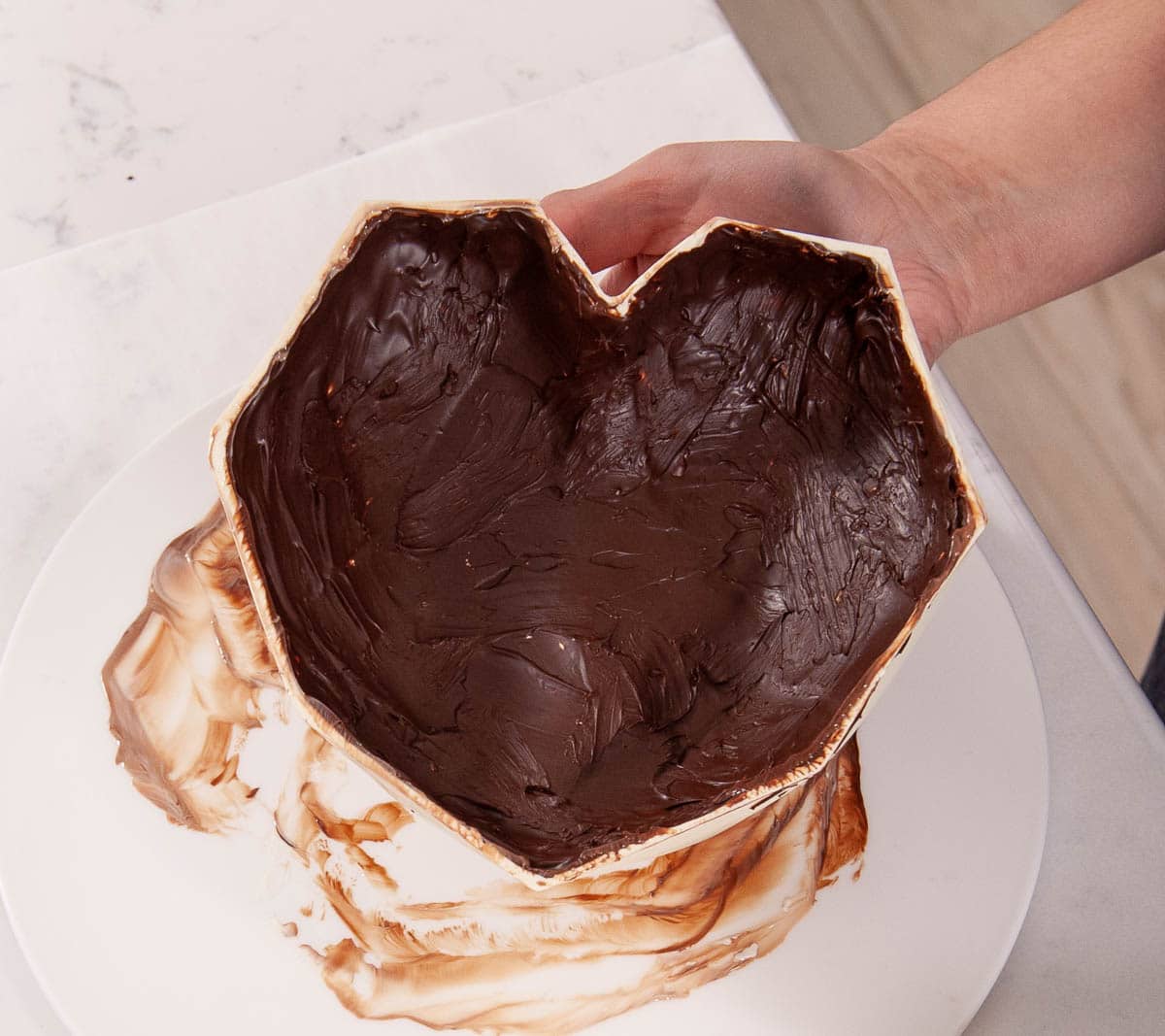 hand holding chocolate breakable heart