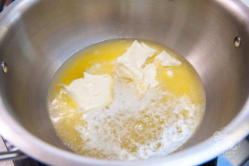 close up of butter melting in a stainless steel pan