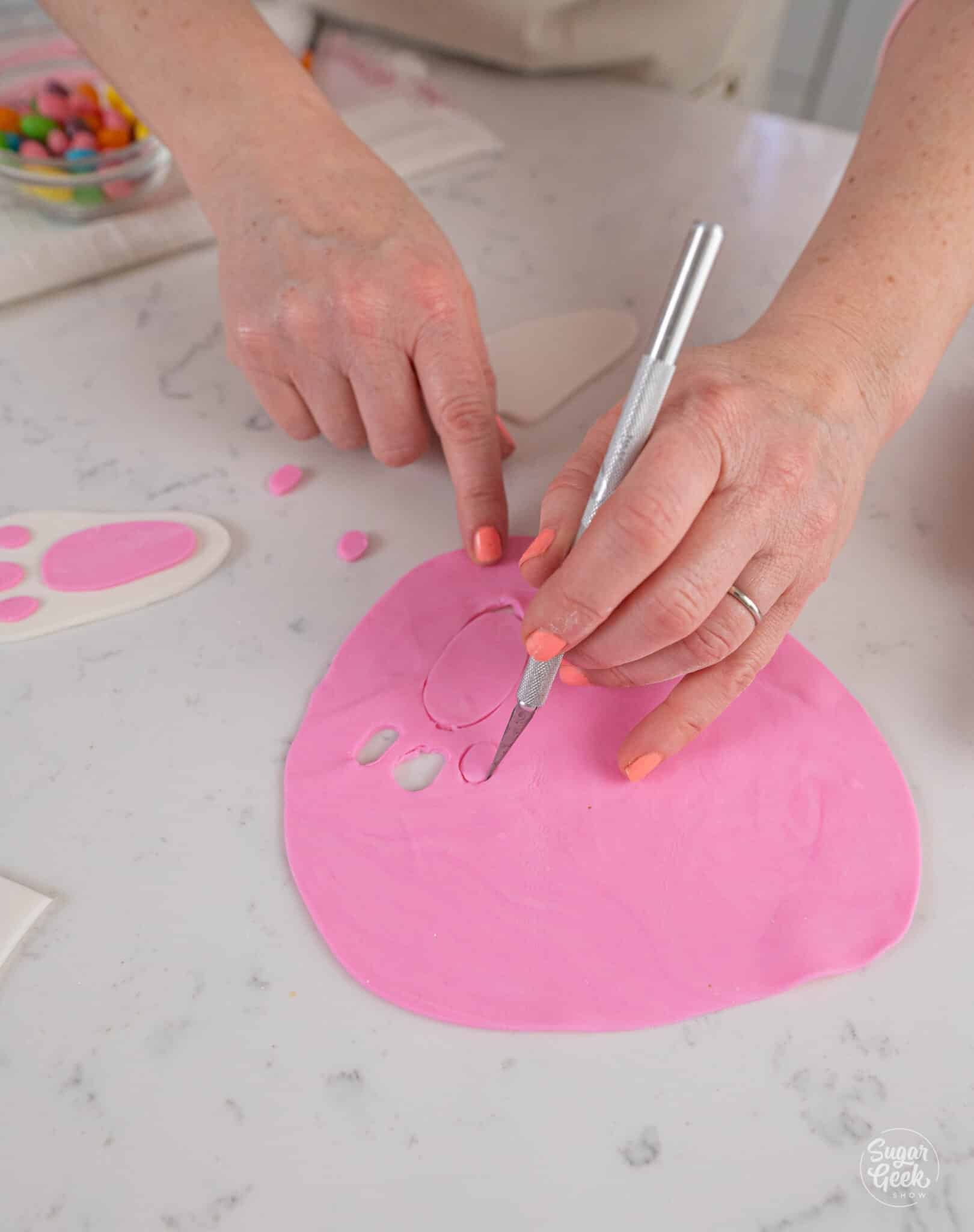 cutting fondant shapes out with an exacto blade