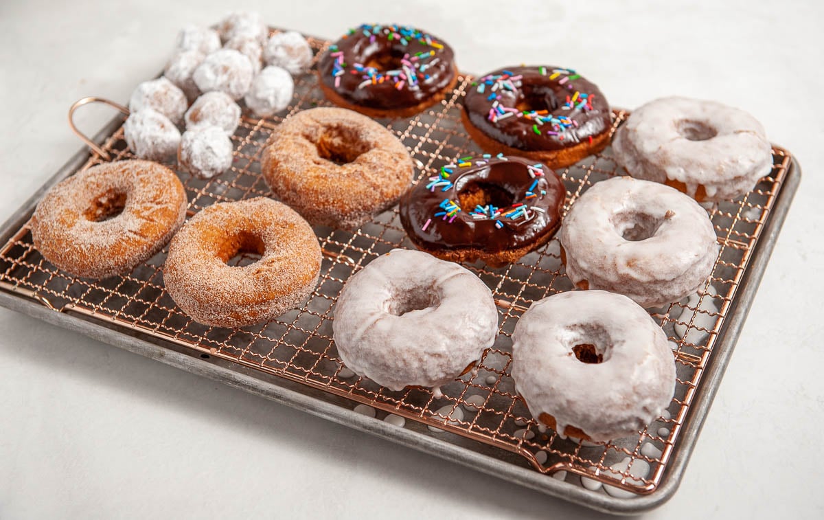 donuts on a cooling rack on a sheet pan