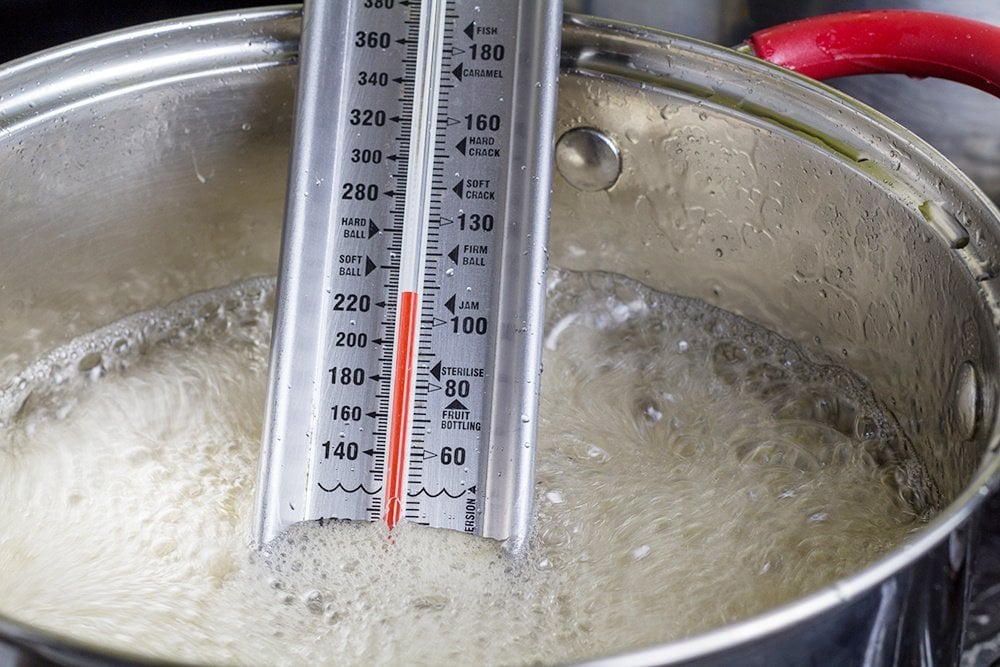 candy thermometer in pot making hard candy