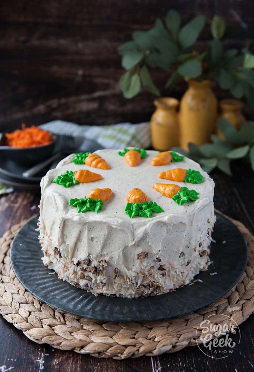 Homestyle carrot cake with pineapple, toasted coconut, candied pecans and big chunks of carrots. Frosted with brown butter cream cheese frosting and buttercream carrots