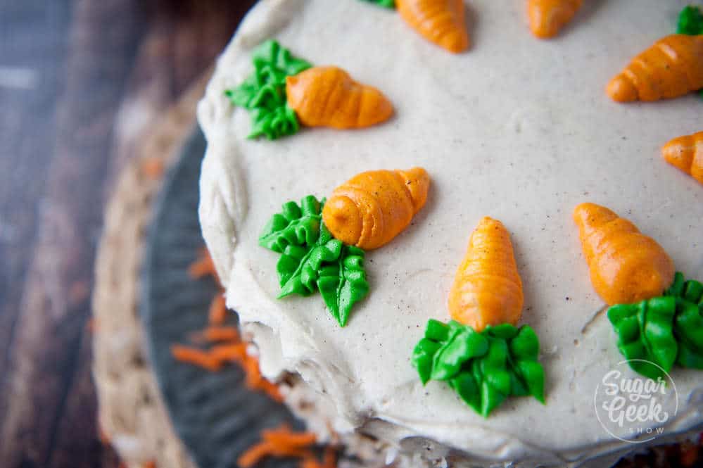piped buttercream carrots on carrot cake