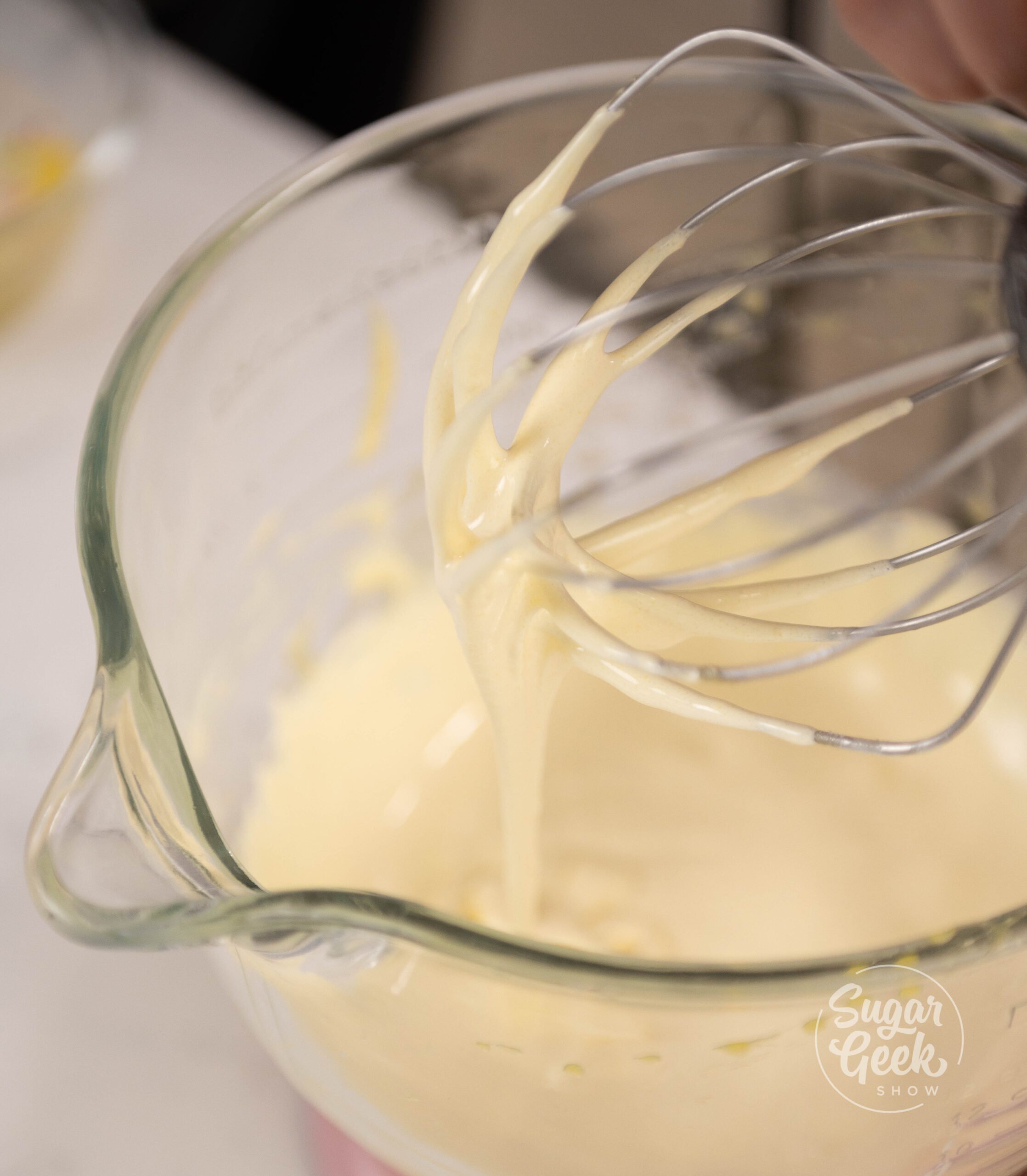 bowl of batter with stand mixer whisk attachment