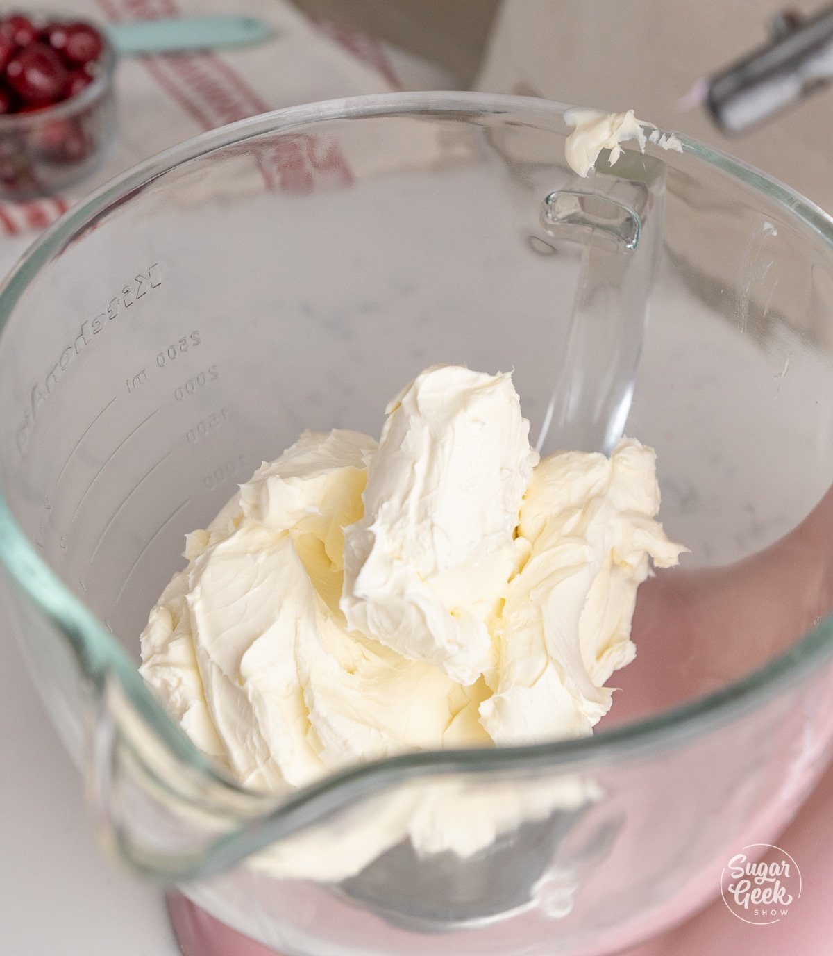 softened cream cheese in a glass stand mixer bowl
