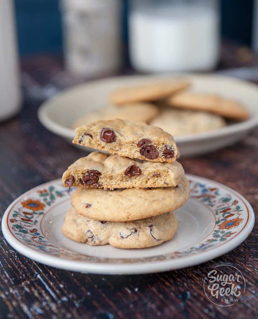 chewy chocolate chip cookies on a floral plate on wooden background