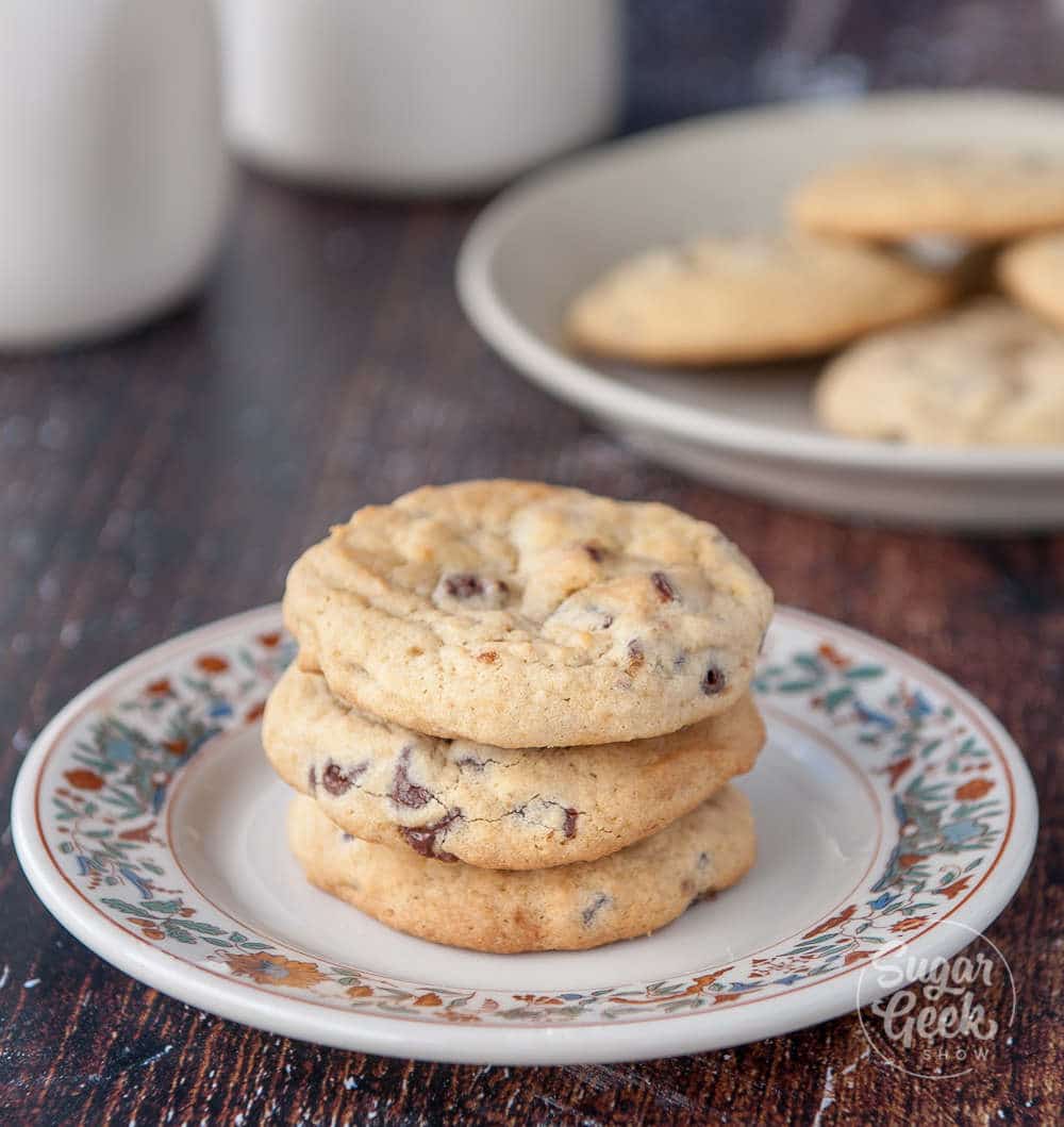 chewy chocolate chip cookies on a floral plate with wooden background