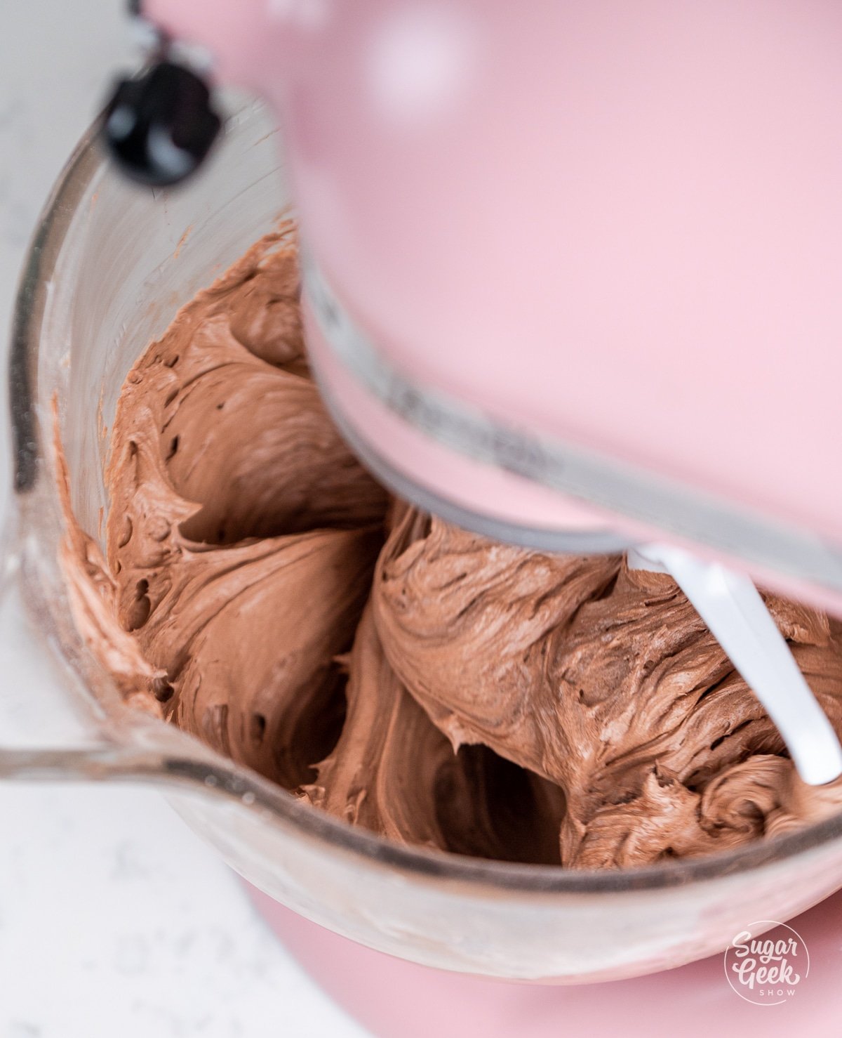 chocolate buttercream mixing in a stand mixer.