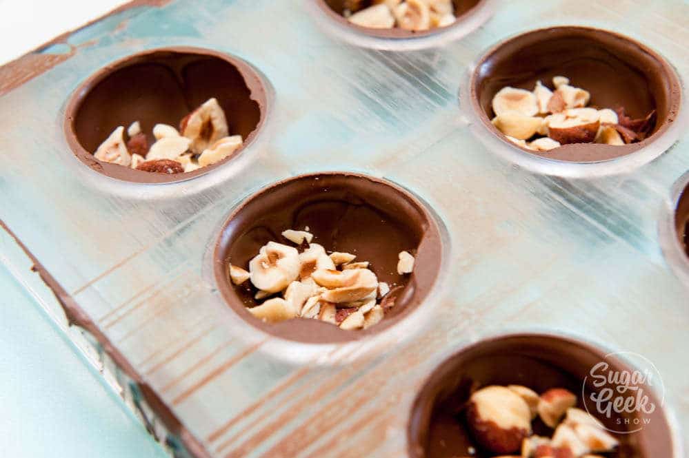 fill chocolate shells with toasted hazelnuts