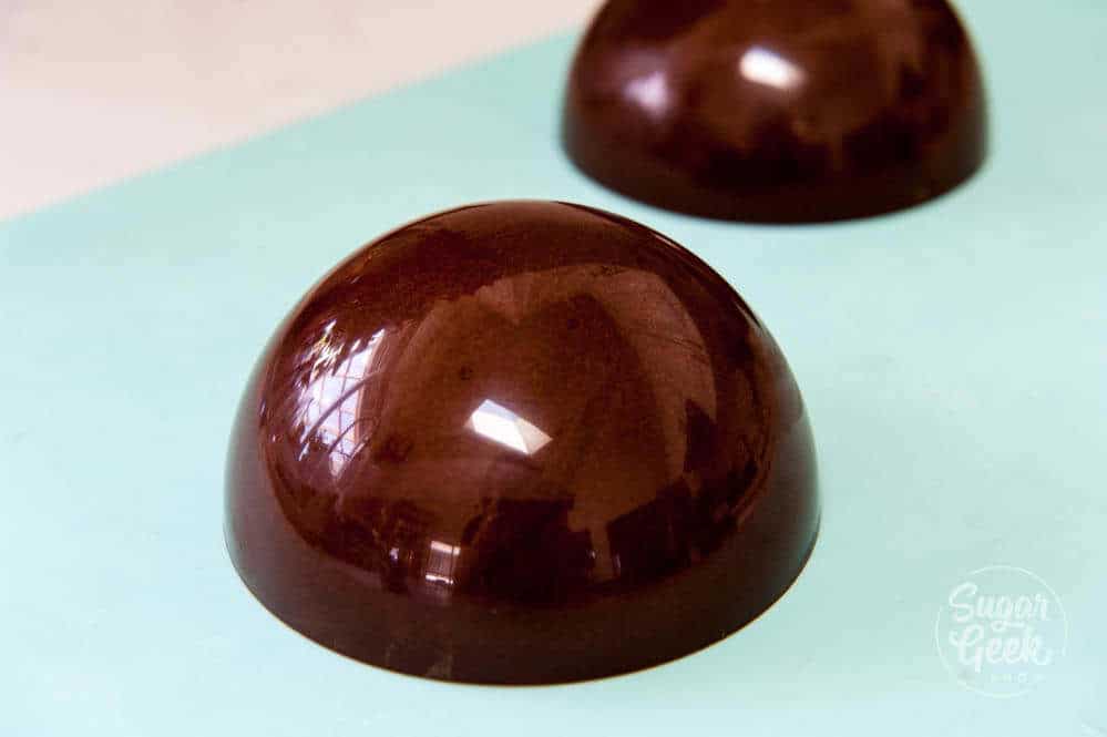 shiny molded chocolate filled with caramel and hazelnuts