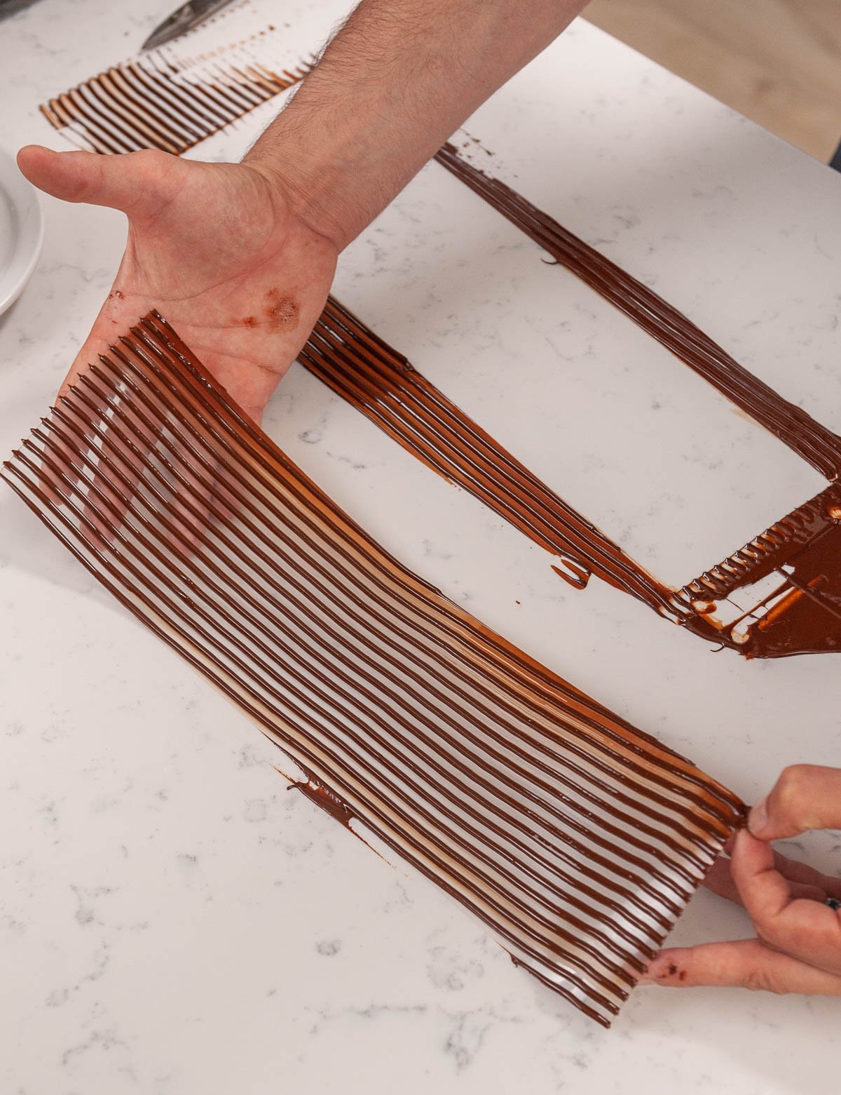 holding acetate with lines of chocolate on top 
