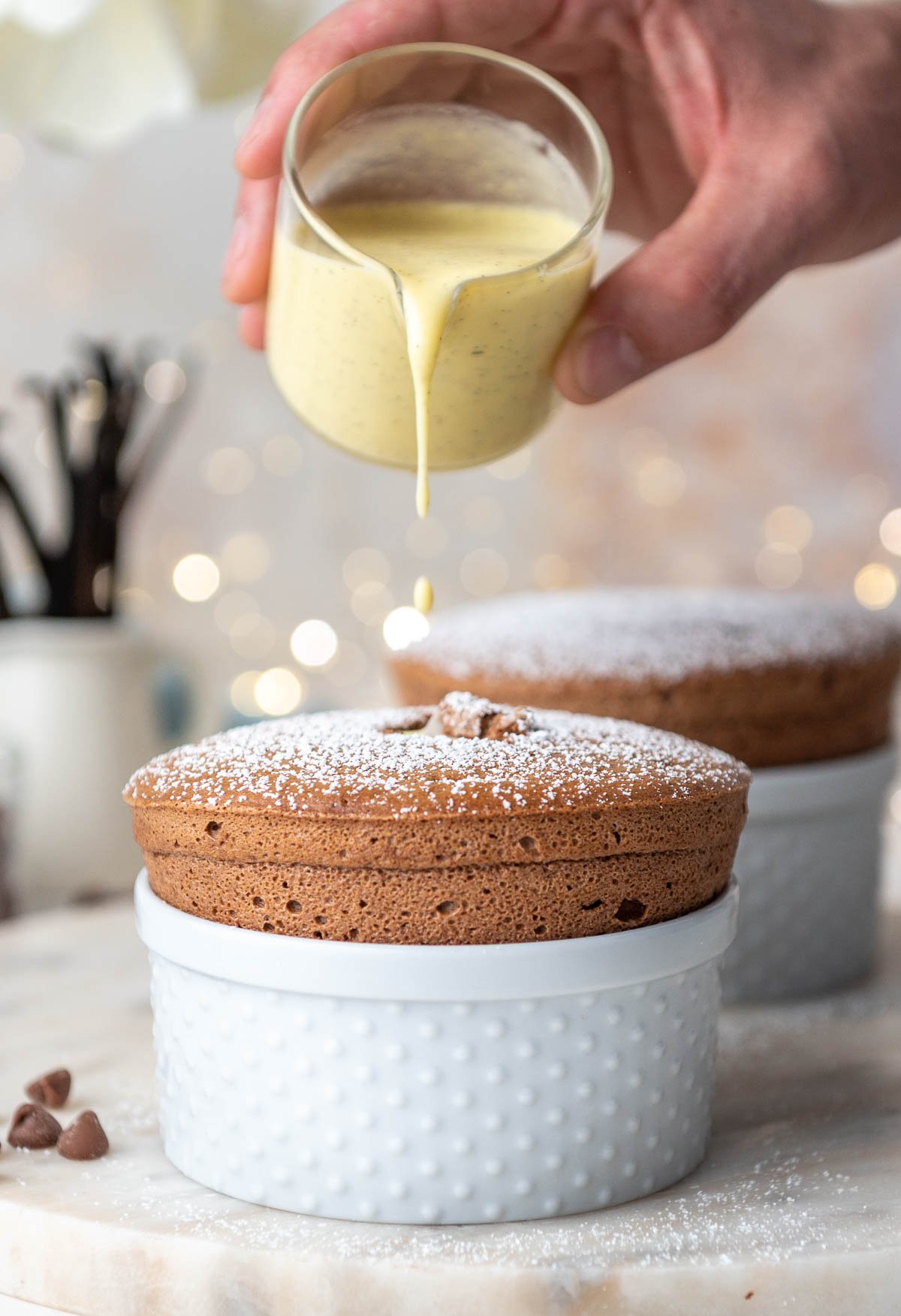 creme anglaise pouring on top of chocolate souffle