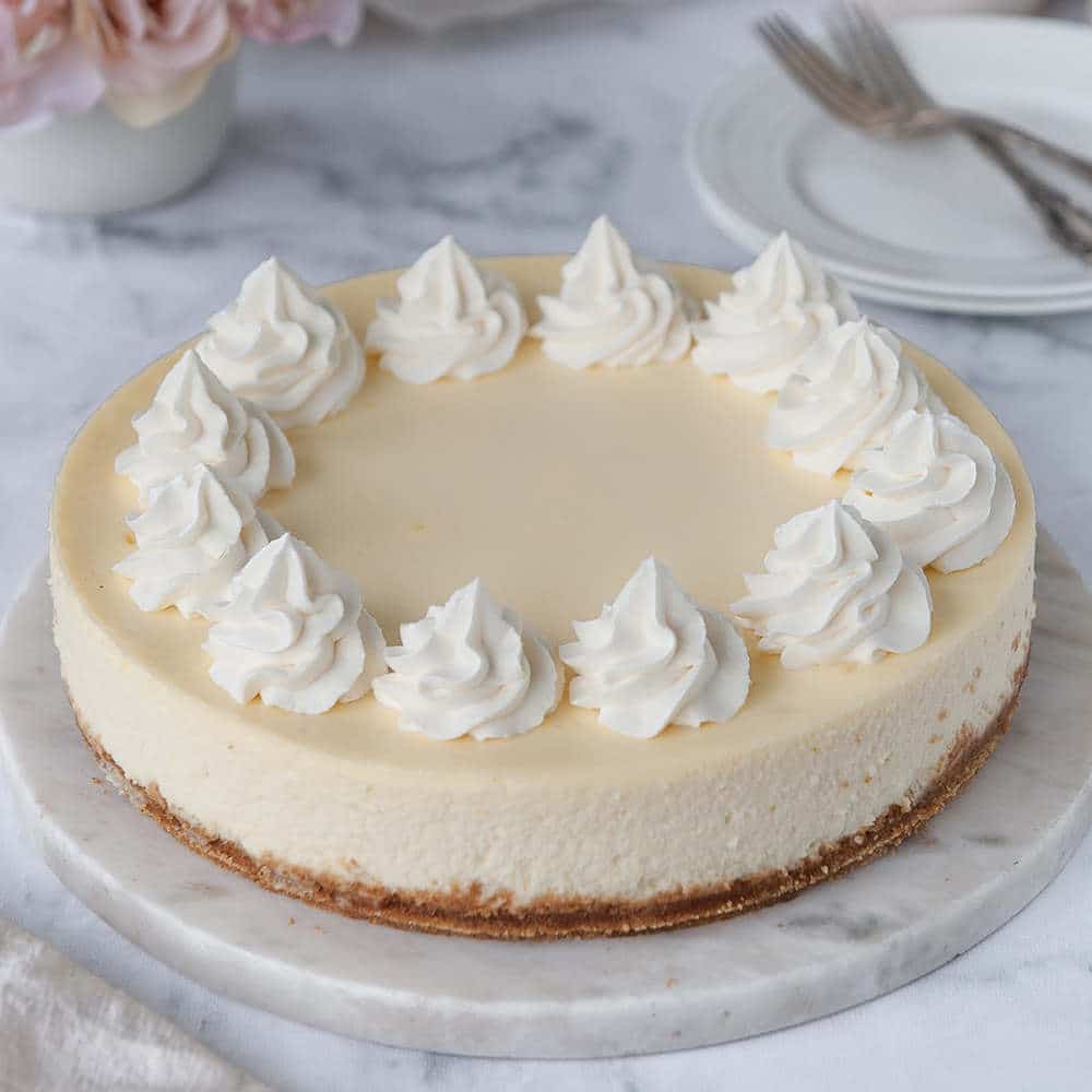 perfect cheesecake with no browning or cracks. Whipped cream piped on top