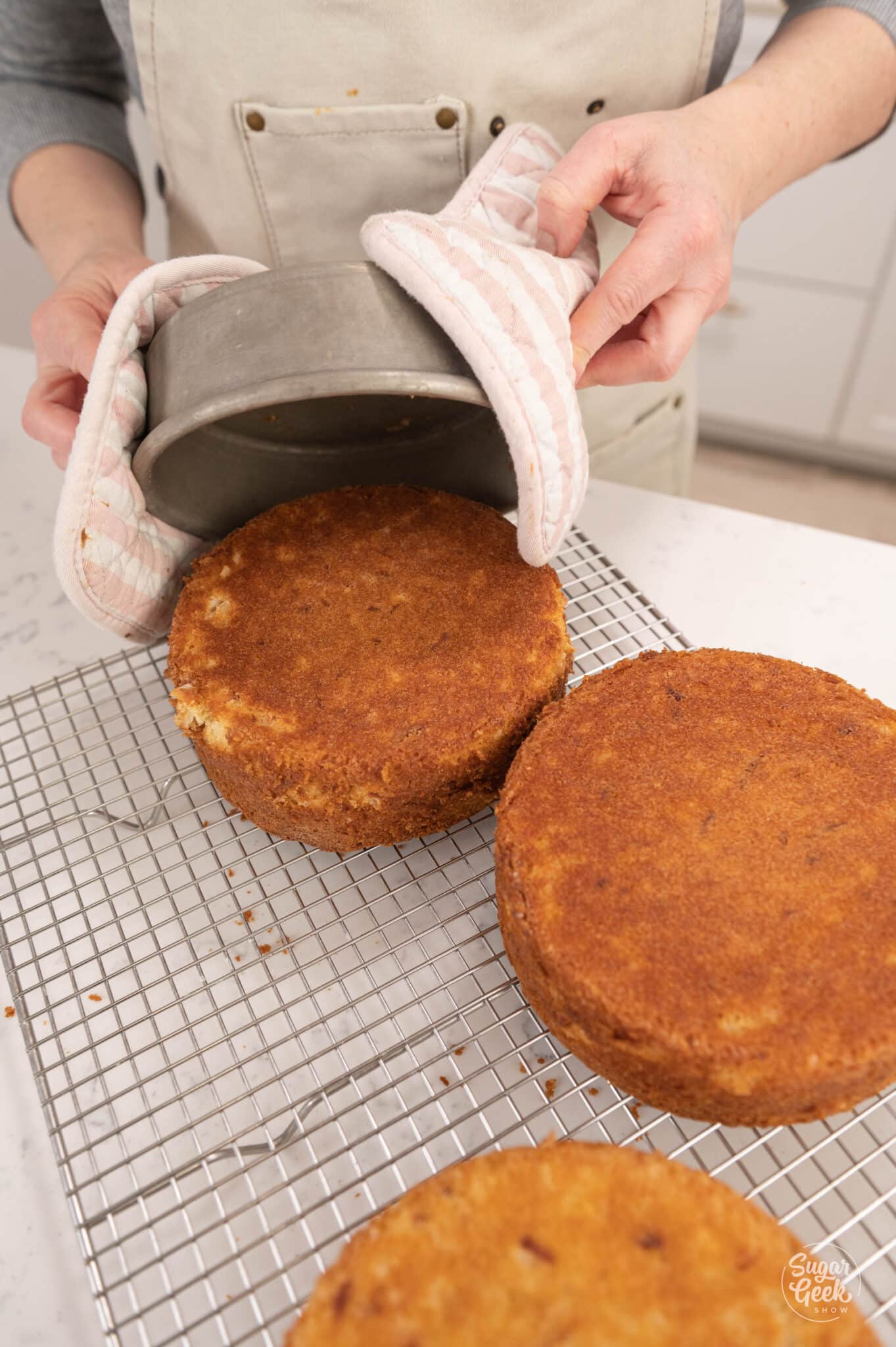 flipping cakes out of their pans and onto a cooling rack