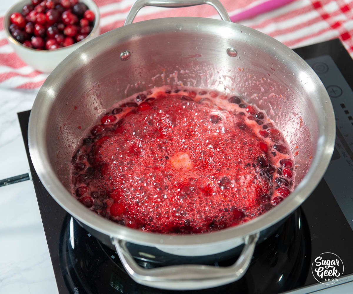 simmering cranberry filling in a stainless steel pot