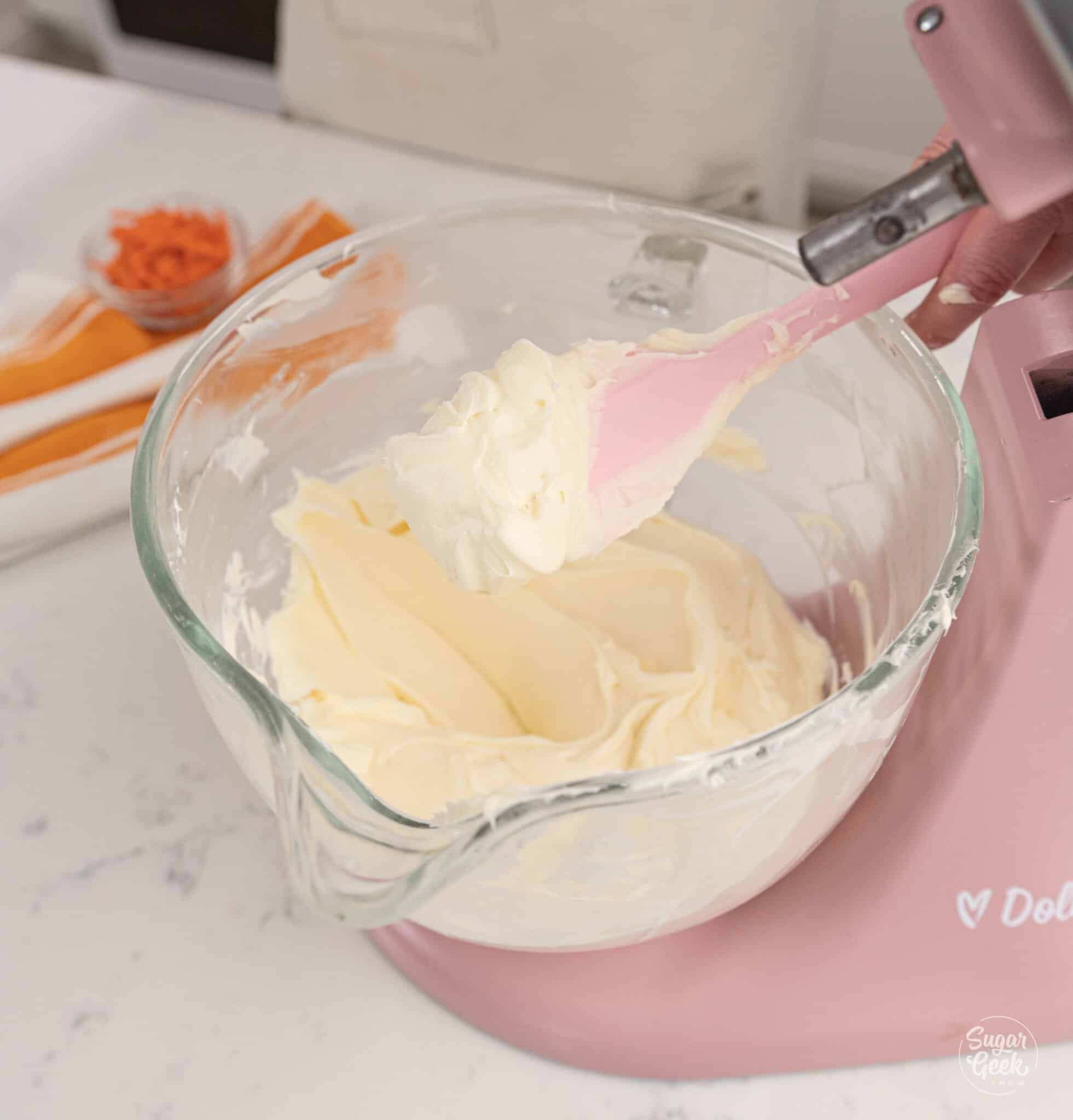 Pink spatula of cream cheese frosting