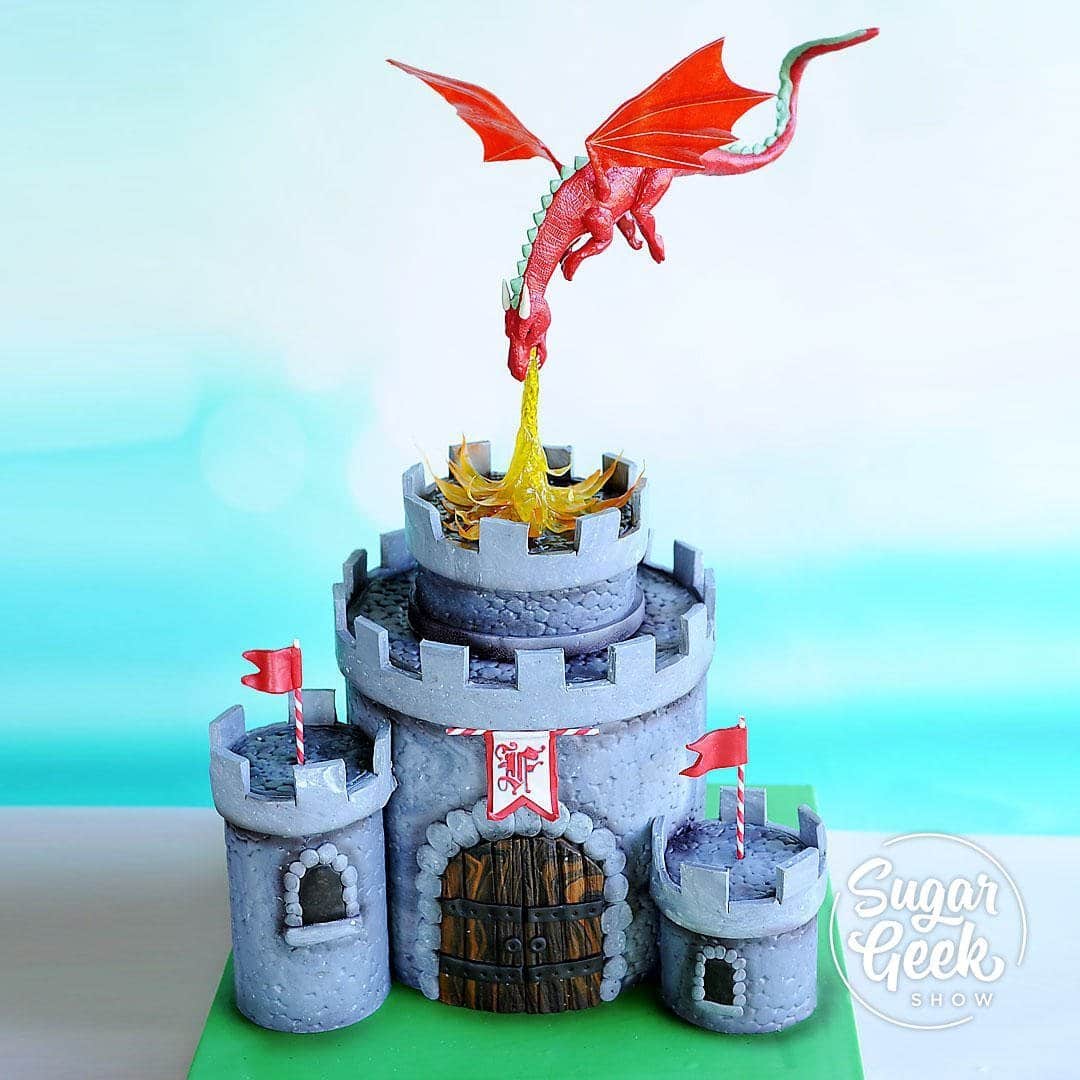 Birthday cakes are one of my favorite things to make and this castle cake with a dragon cake topper is the perfect sort of cake to make for the little king or queen's birthday. Learn how to make a dragon cake topper with posable wings, isomalt dragon fire, all the little details on the castle, how to hand-letter fancy monograms and more!
