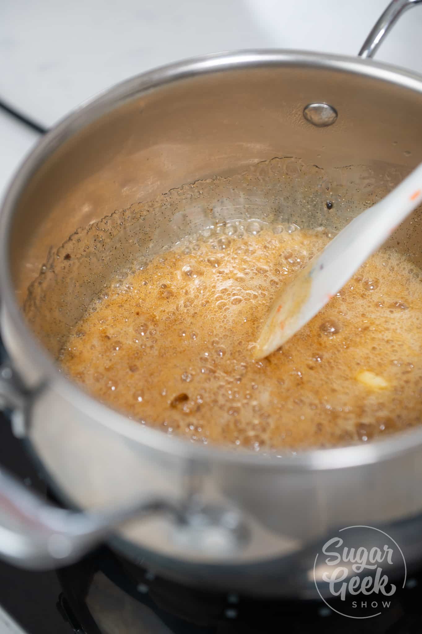 picture of sugar and honey mixture cooking in saucepan.