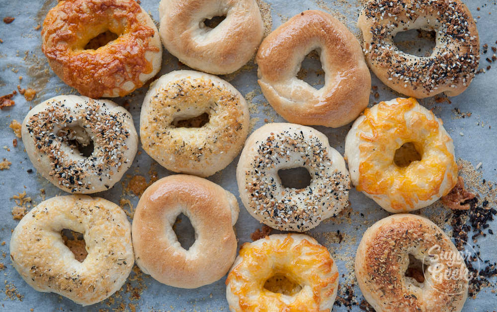 easy homemade bagels with different toppings on a sheet pan