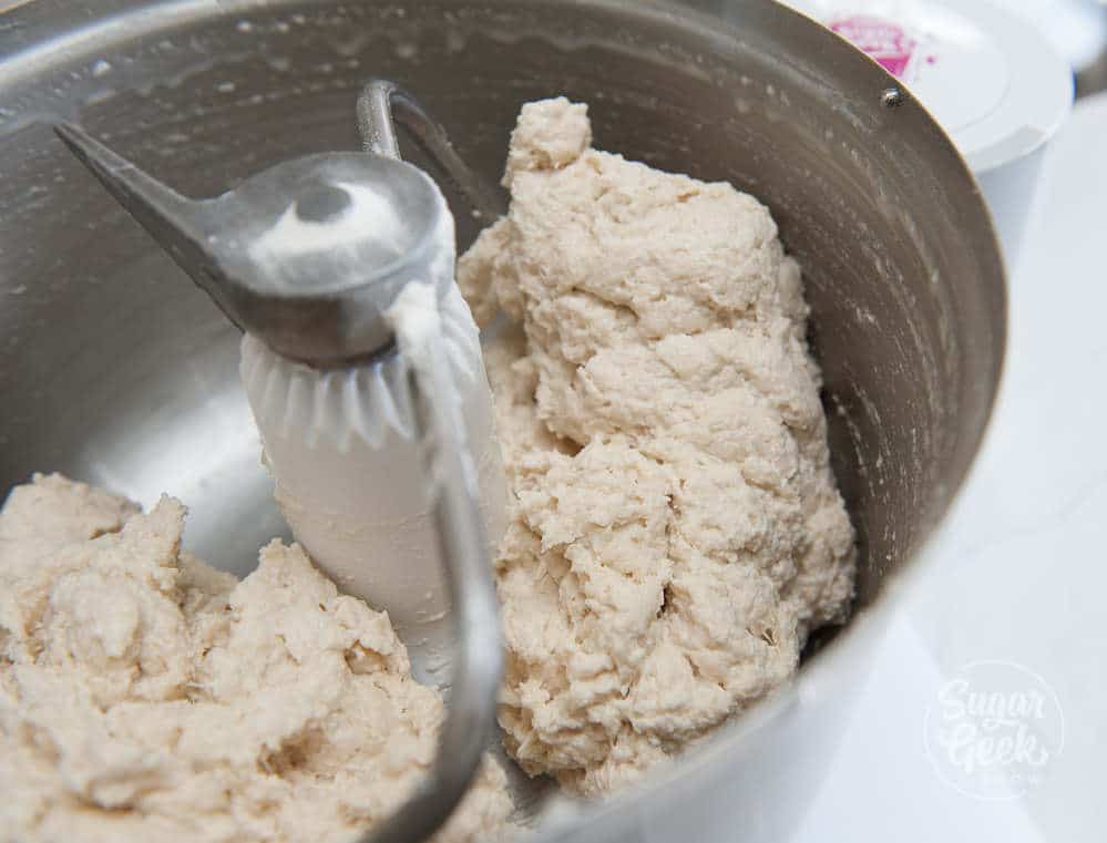 bagel dough in mixing bowl with dough hook attached