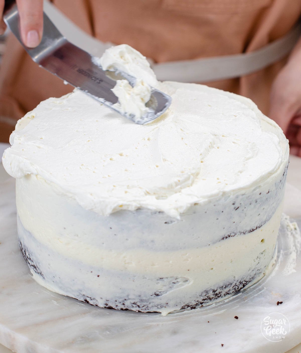 covering the cake in a thin layer of buttercream
