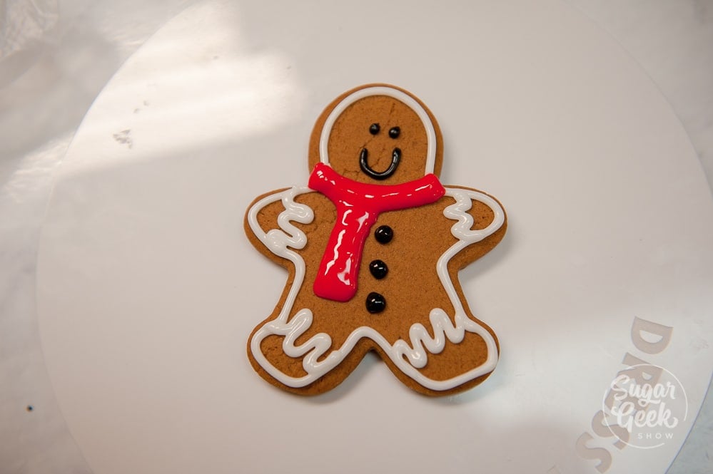 Add some dots to the front of the gingerbread man for his buttons