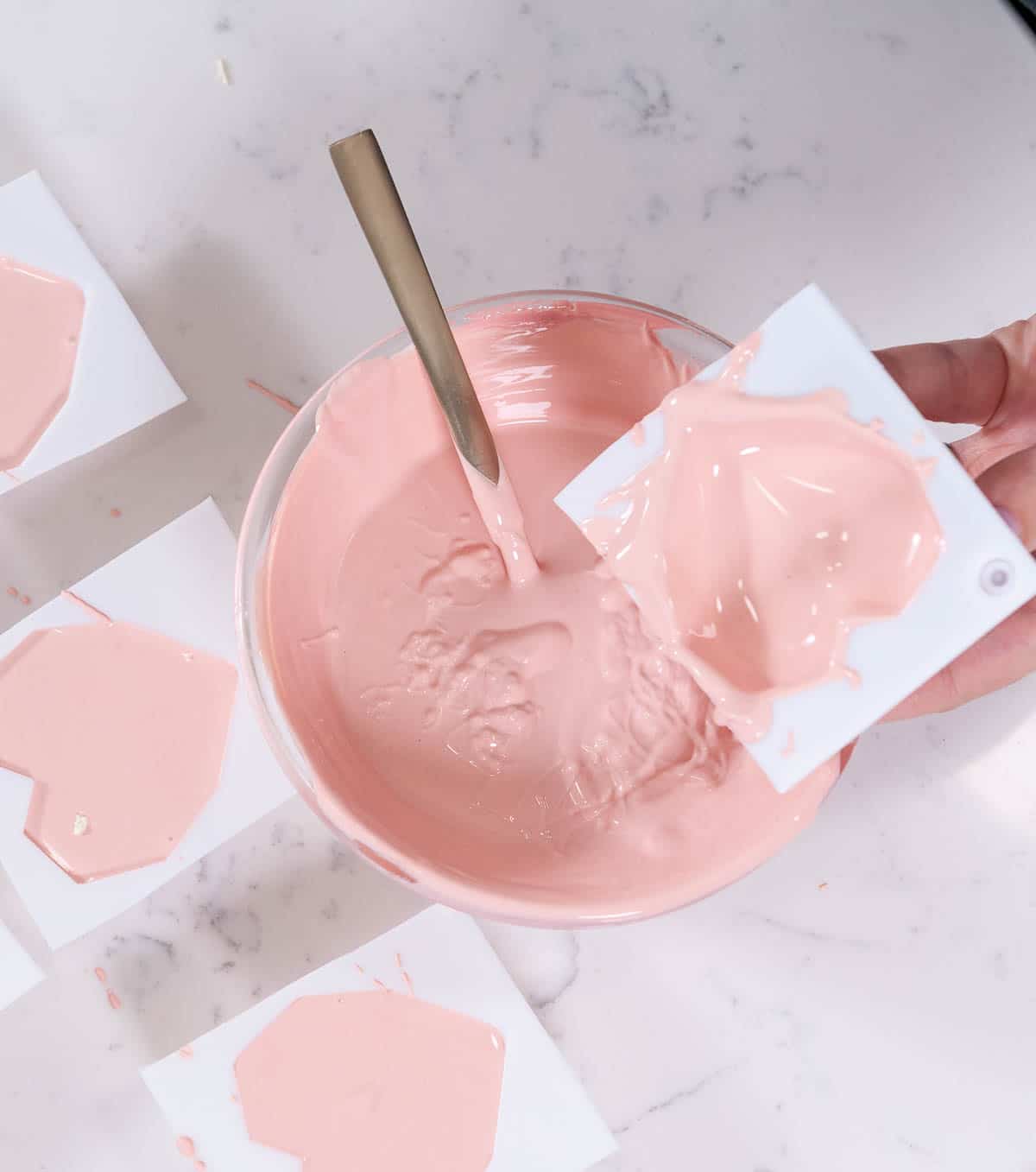 emptying heart hot chocolate molds over a pink bowl