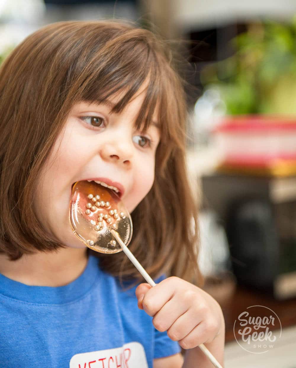 little girl eating homemade lollipop