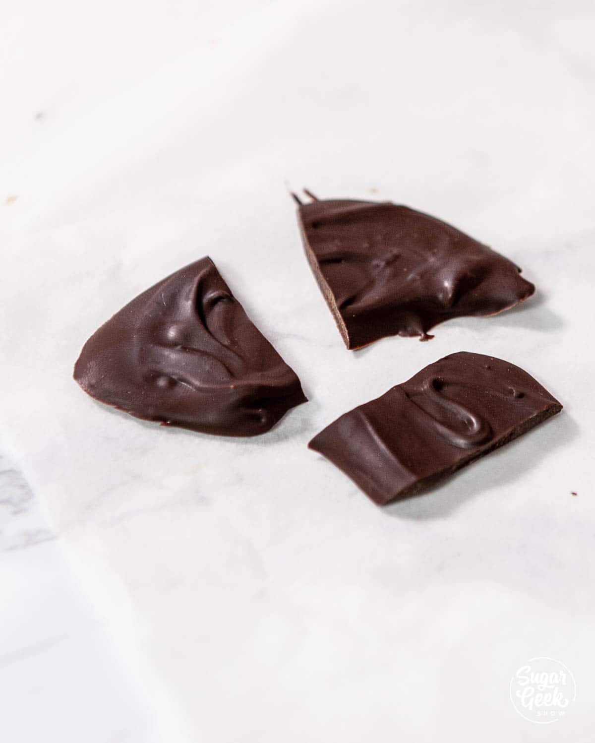 three broken pieces of chocolate 