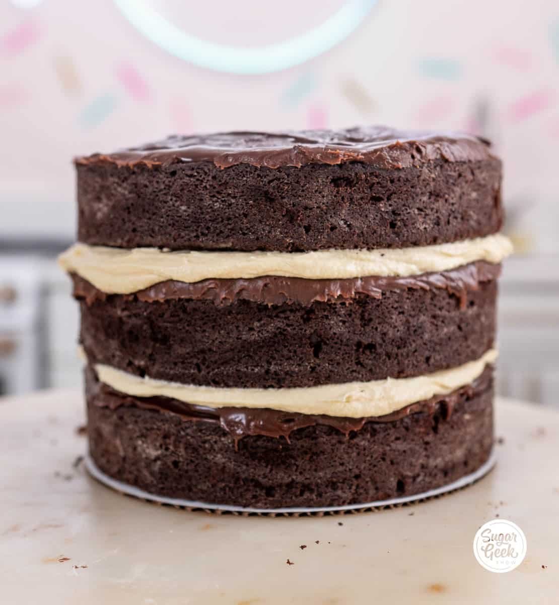 a naked chocolate irish cream cake stacked with three layers