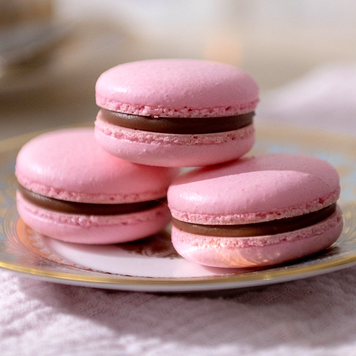 close up of three macarons on a plate