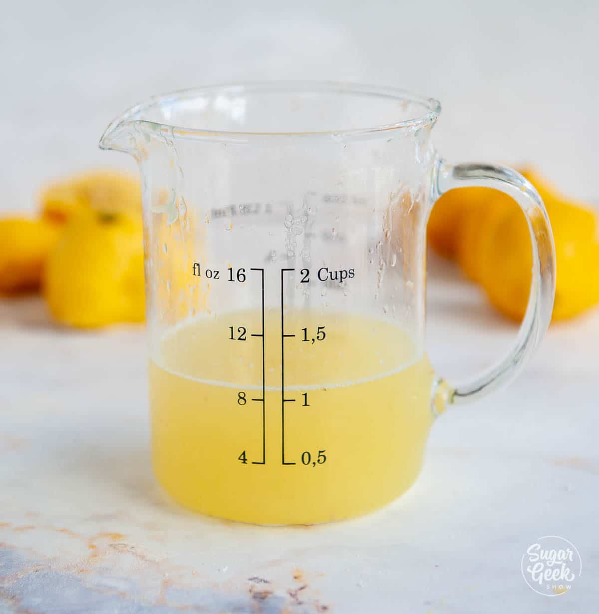 closeup of lemon juice in a measuring cup