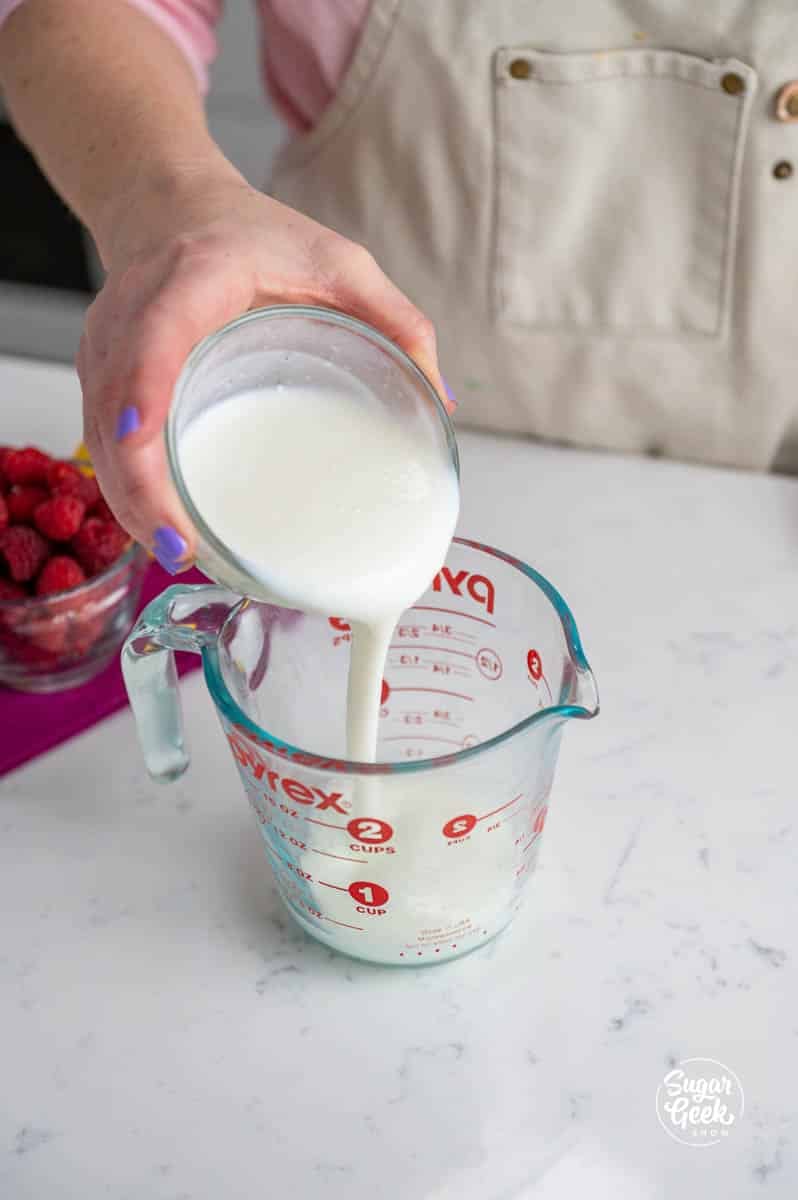 pouring buttermilk from a bowl to a container