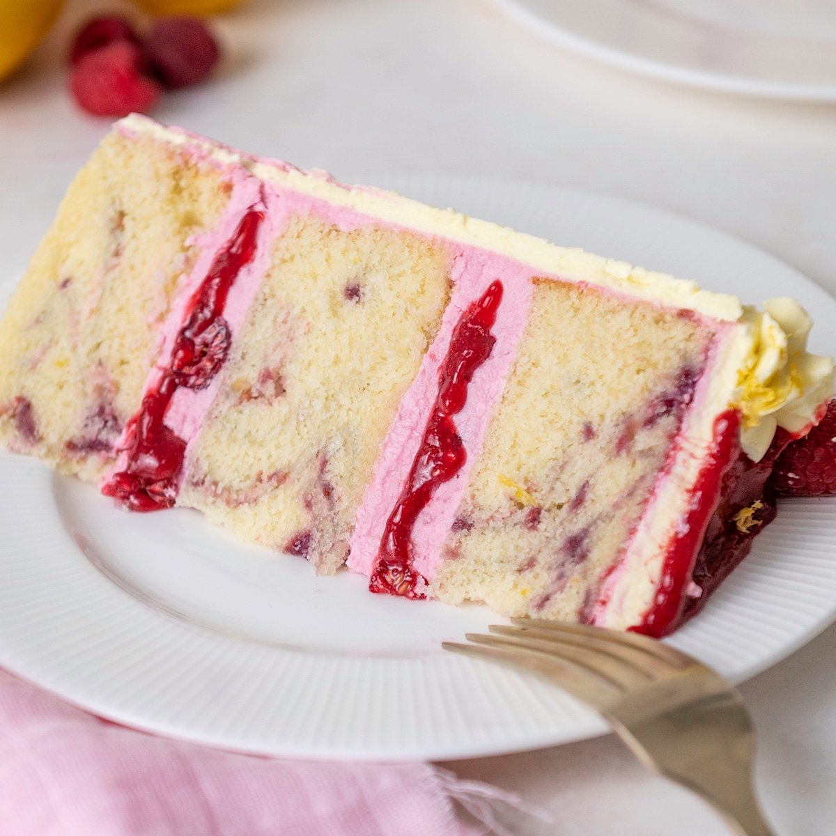 slice of lemon raspberry cake on a plate