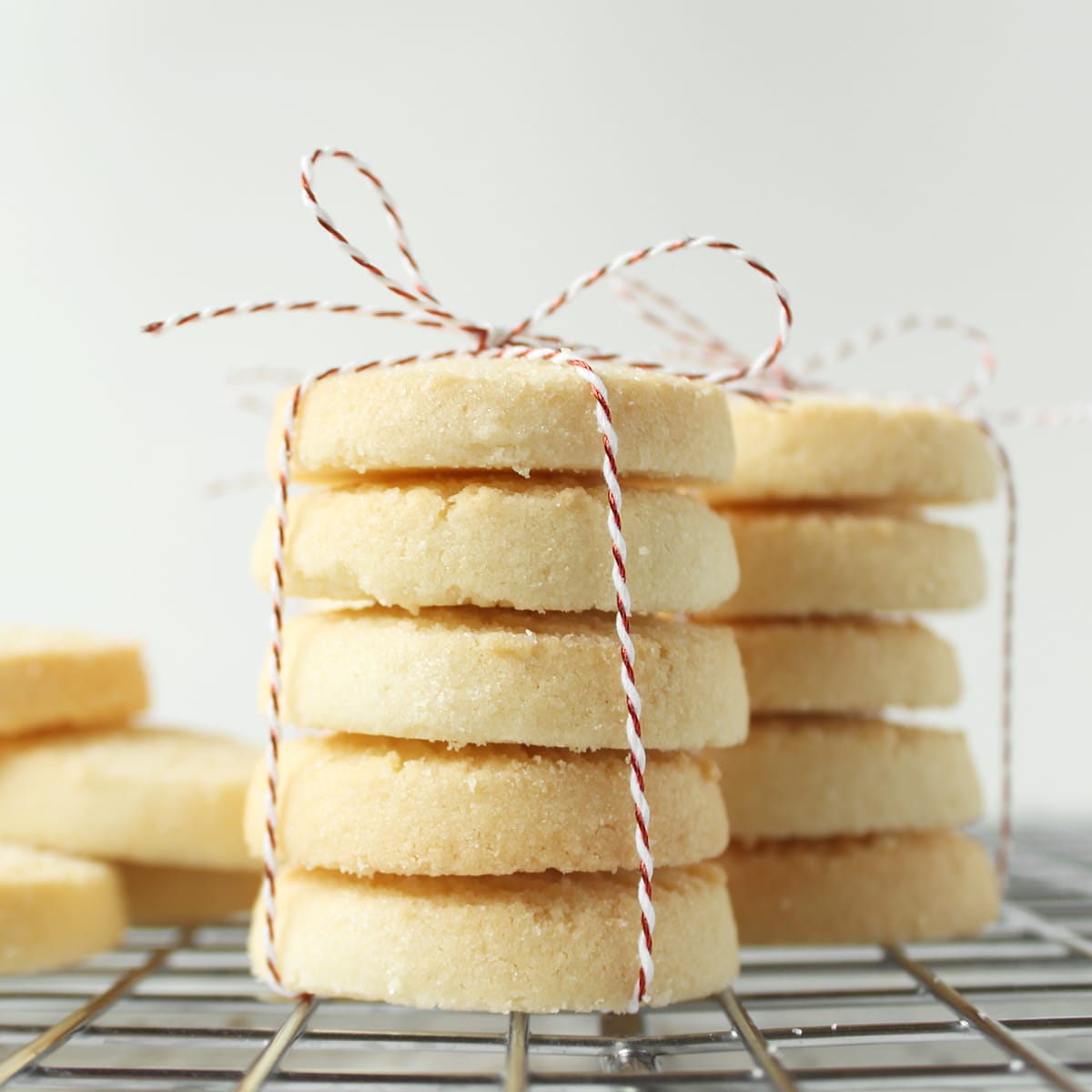 stack of lemon shortbread cookies tied with red and white twine
