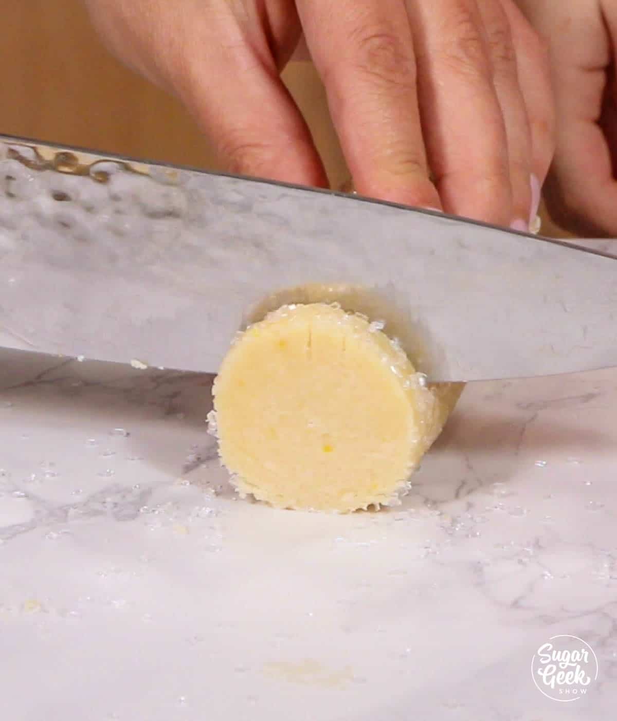 slicing lemon shortbread cookie dough with a knife