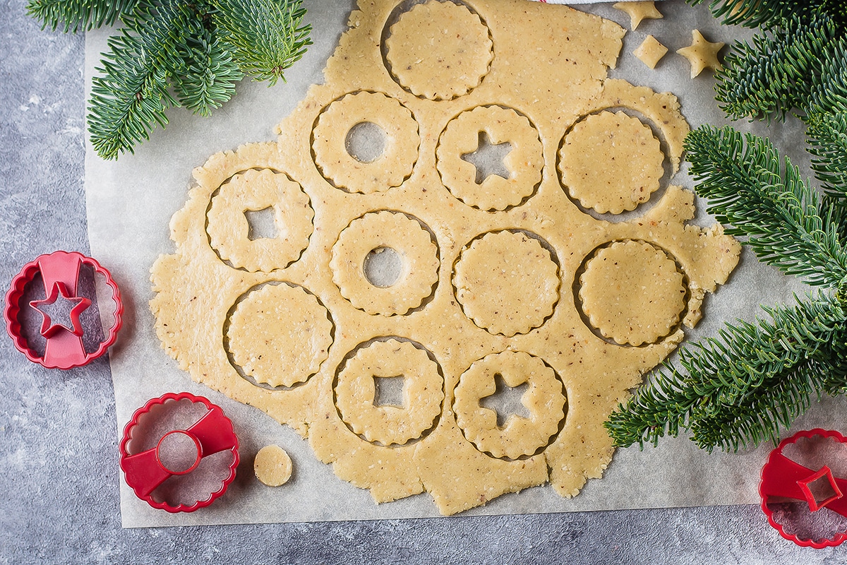 Linzer cookies being cut from dough shot from above
