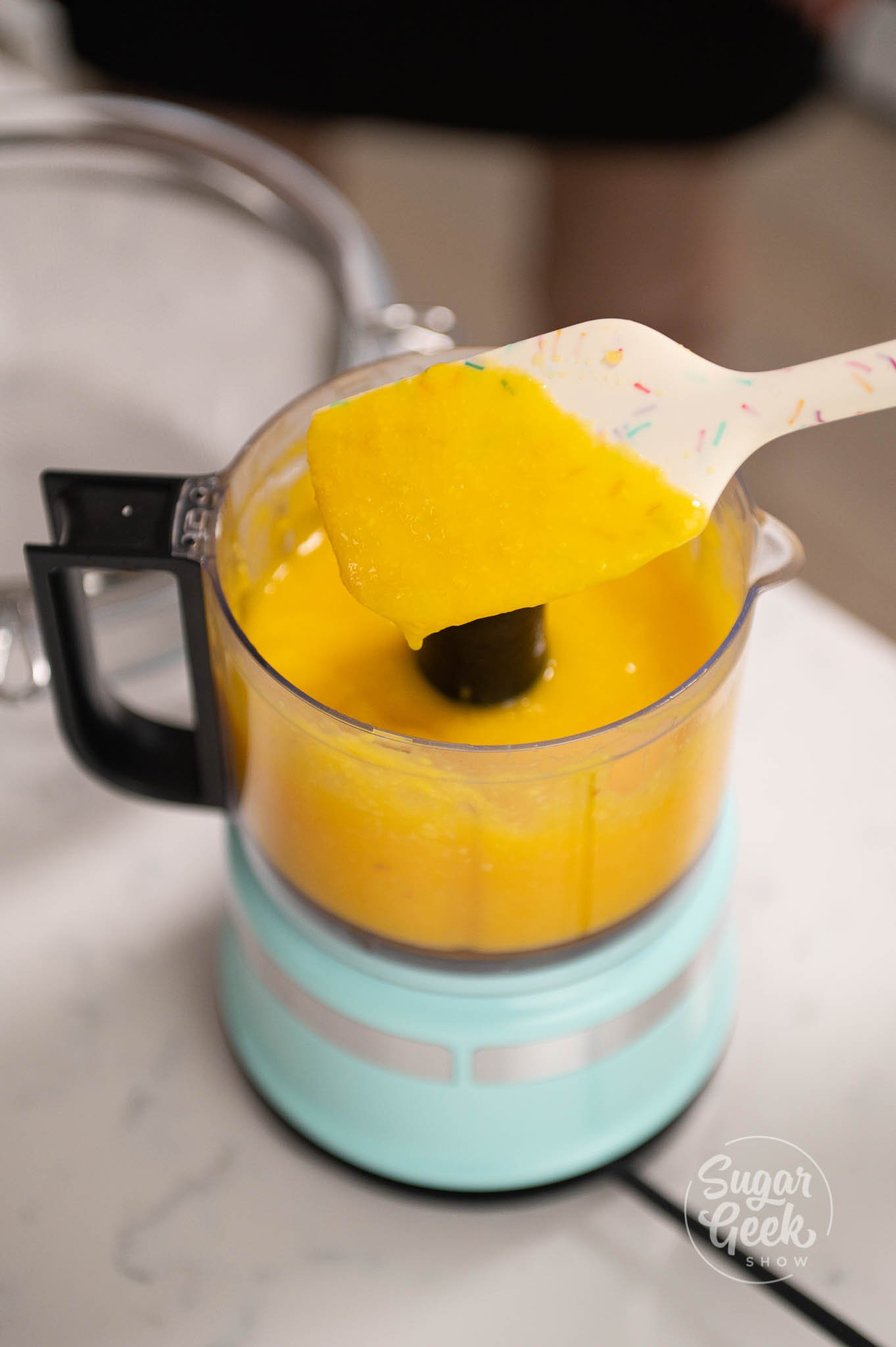 spatula covered in mango puree.