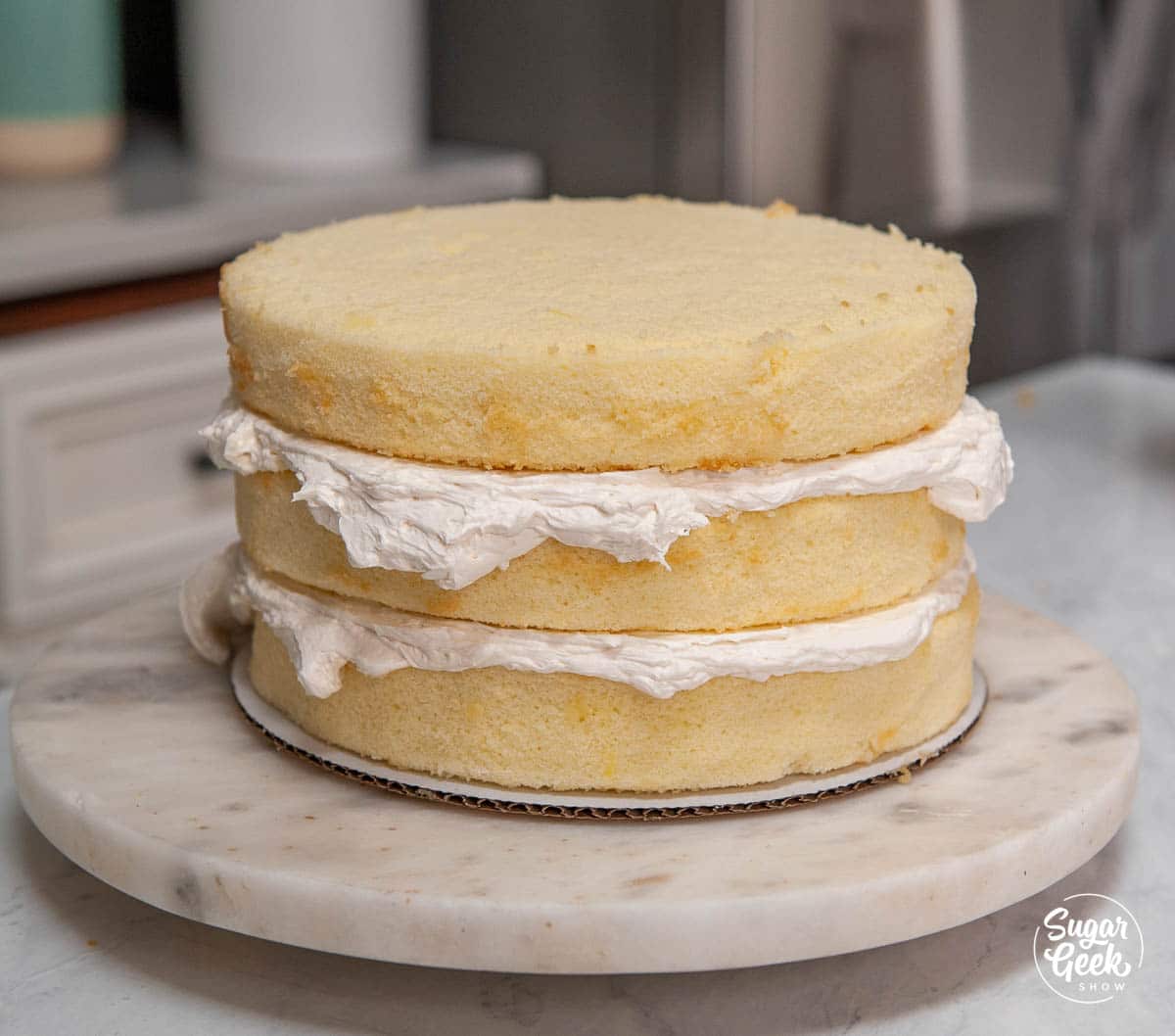three layers of vanilla cake with vanilla buttercream