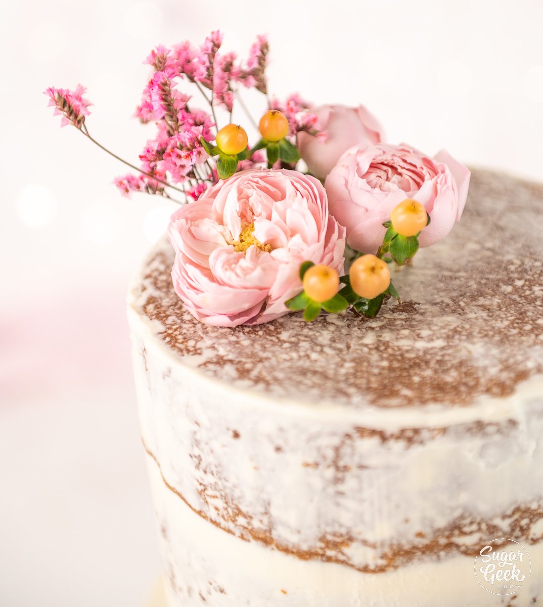 naked wedding cake decorated with flowers