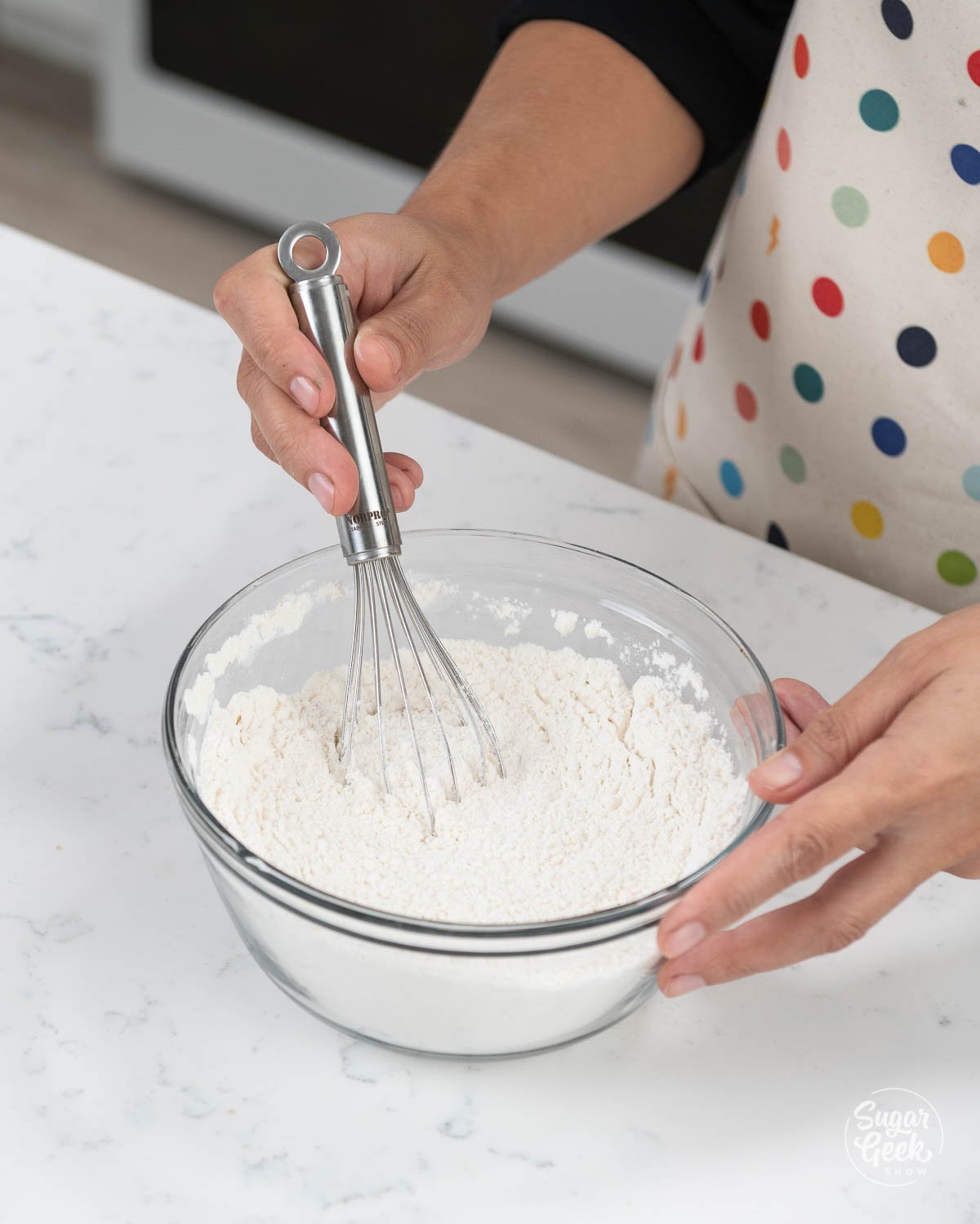 combining dry ingredients in a mixing bowl
